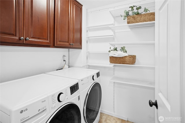 laundry area featuring washer and dryer and cabinet space