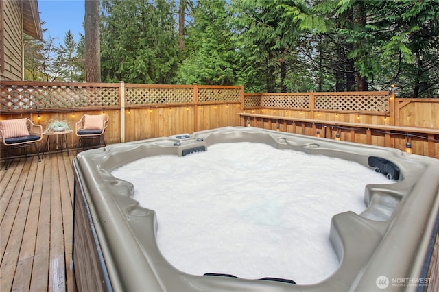 deck featuring an outdoor hot tub