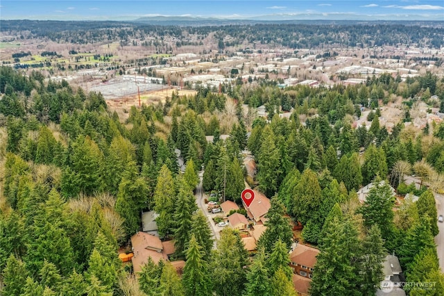 birds eye view of property featuring a wooded view