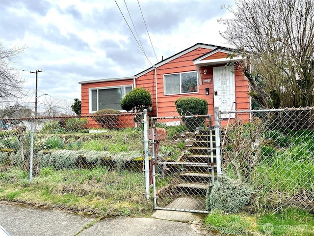 bungalow-style house featuring a fenced front yard and a gate