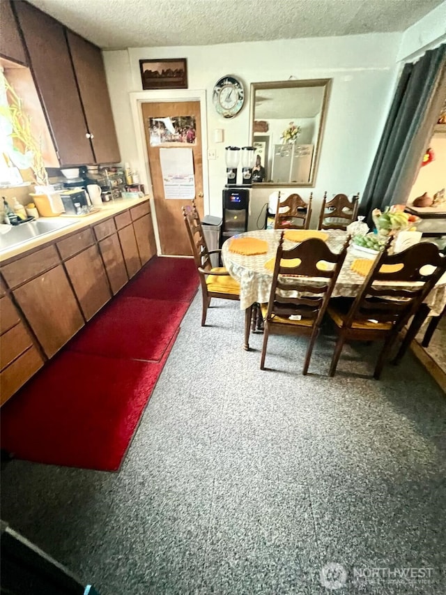 dining area featuring a textured ceiling