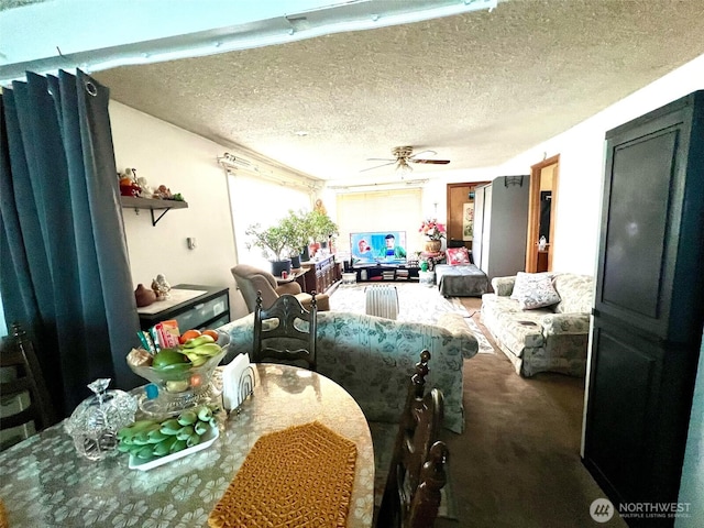 dining room with a textured ceiling, a ceiling fan, and carpet floors