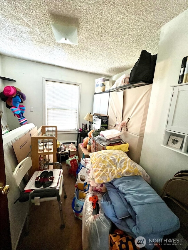 bedroom with a textured ceiling and carpet flooring