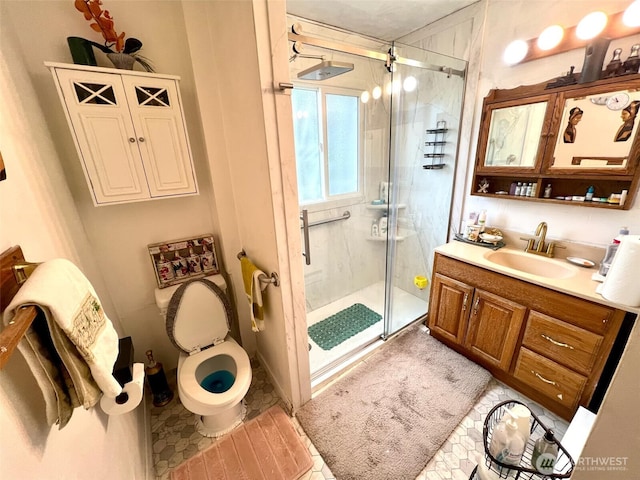 full bathroom featuring toilet, a stall shower, and vanity