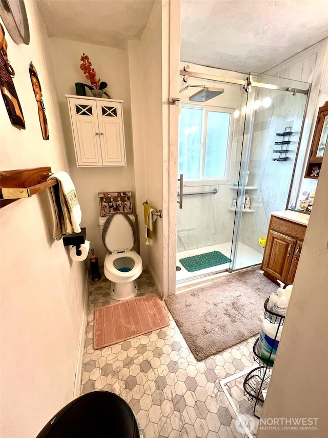 full bath with toilet and a shower stall