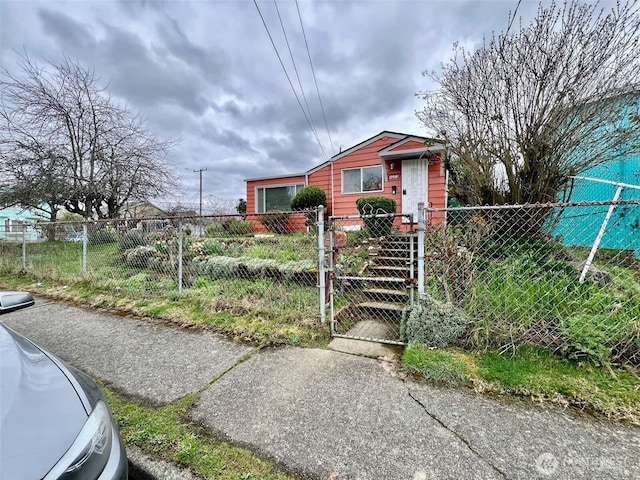 bungalow-style home with a fenced front yard and a gate