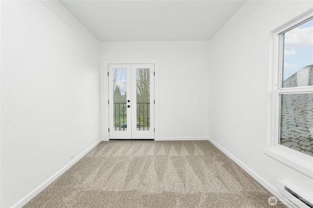 unfurnished room featuring french doors, a healthy amount of sunlight, baseboards, and carpet floors