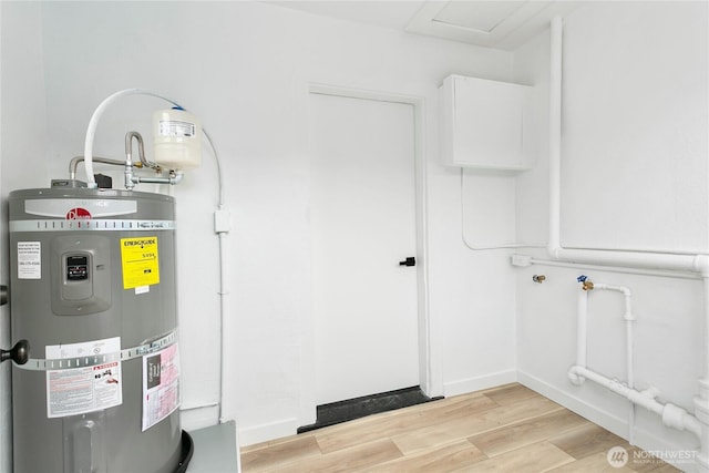 utility room featuring strapped water heater