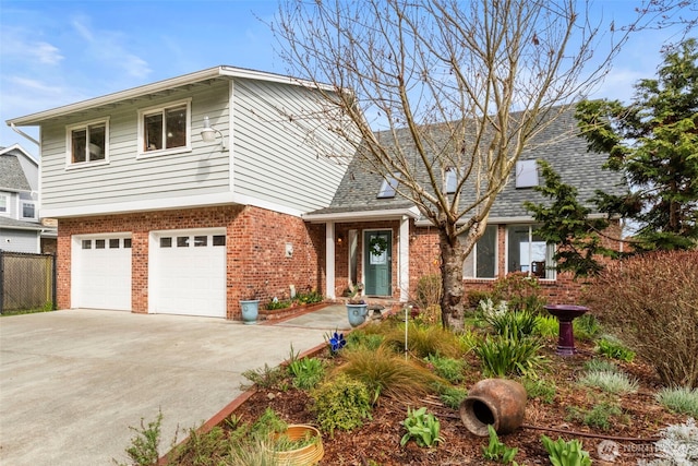 view of front of property with brick siding, fence, a garage, and concrete driveway