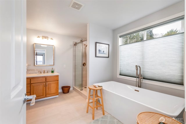 full bath with a stall shower, vanity, visible vents, and a freestanding bath