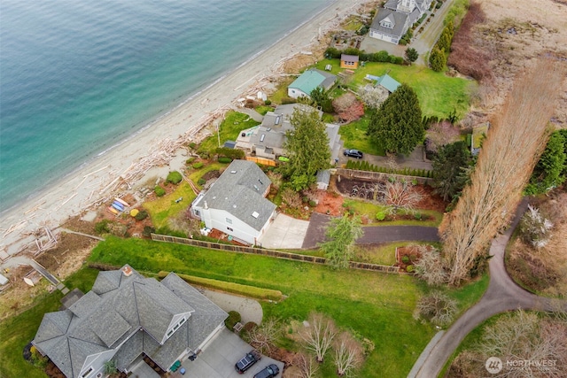birds eye view of property with a water view and a beach view
