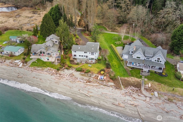 drone / aerial view featuring a beach view and a water view