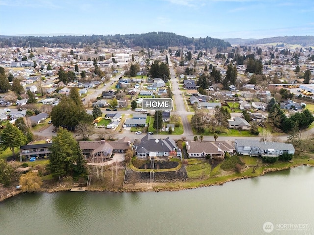 drone / aerial view featuring a residential view and a water view