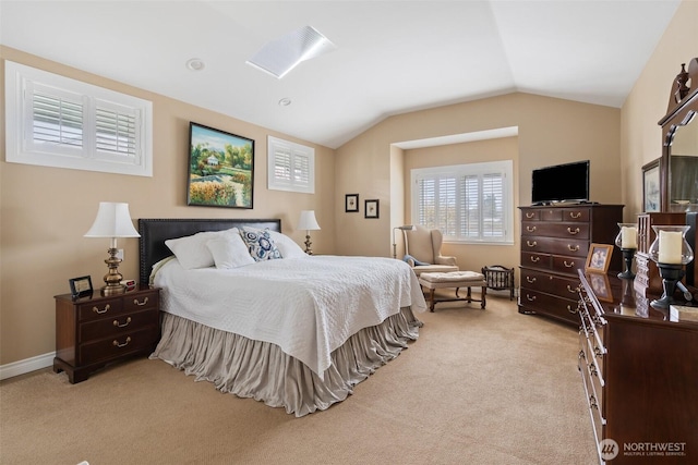 bedroom featuring baseboards, light carpet, and vaulted ceiling