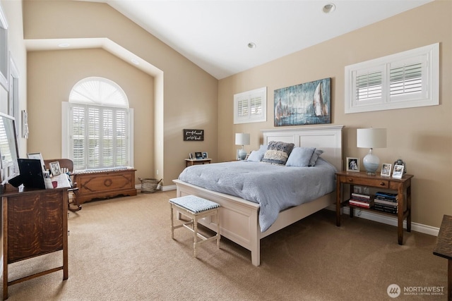 carpeted bedroom featuring vaulted ceiling and baseboards