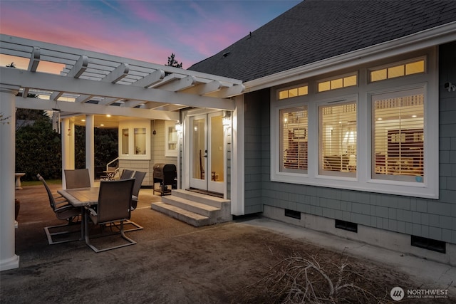 view of patio with entry steps, a pergola, and outdoor dining area