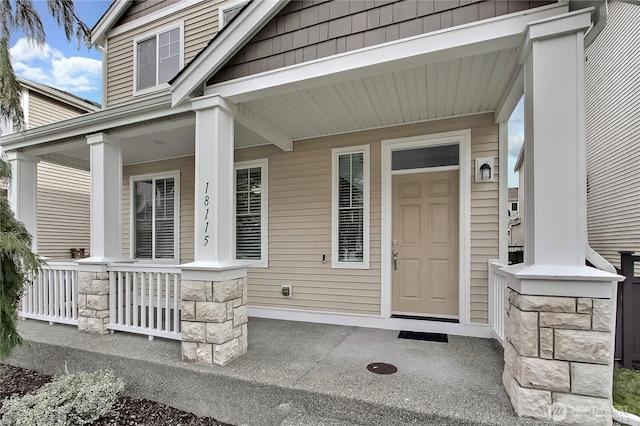 view of exterior entry with covered porch