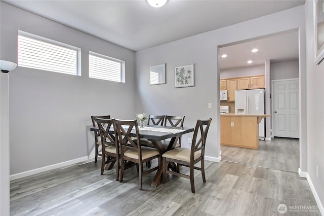 dining area with recessed lighting, baseboards, and light wood finished floors