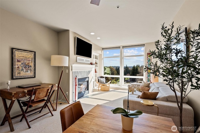 carpeted dining room with visible vents, recessed lighting, a tile fireplace, and expansive windows