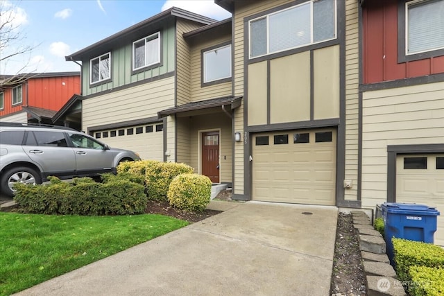 multi unit property featuring a garage, board and batten siding, and driveway