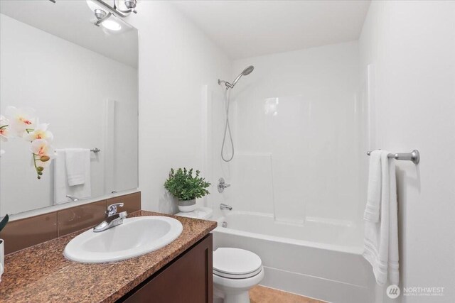 bathroom with vanity, toilet, and shower / washtub combination