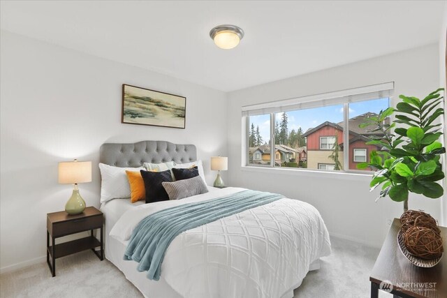 carpeted bedroom featuring baseboards