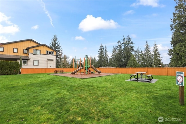 view of jungle gym featuring a yard and fence