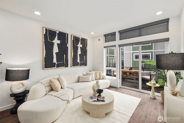 living area featuring recessed lighting, baseboards, and wood finished floors