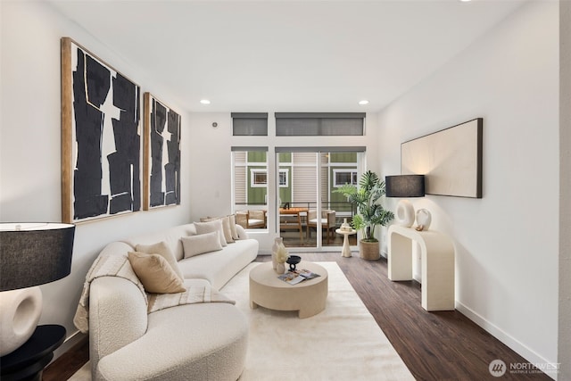 living room featuring dark wood finished floors, recessed lighting, and baseboards