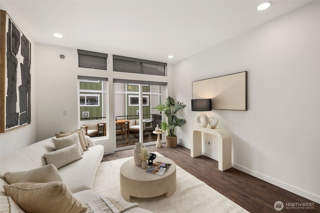 living room with recessed lighting, baseboards, and wood finished floors