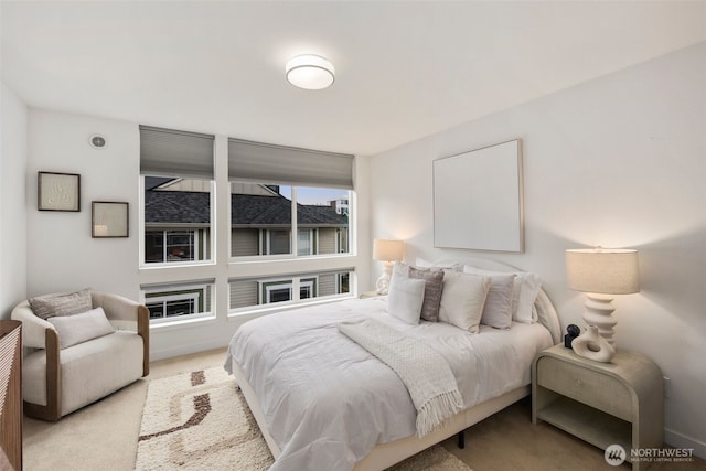 bedroom featuring light carpet