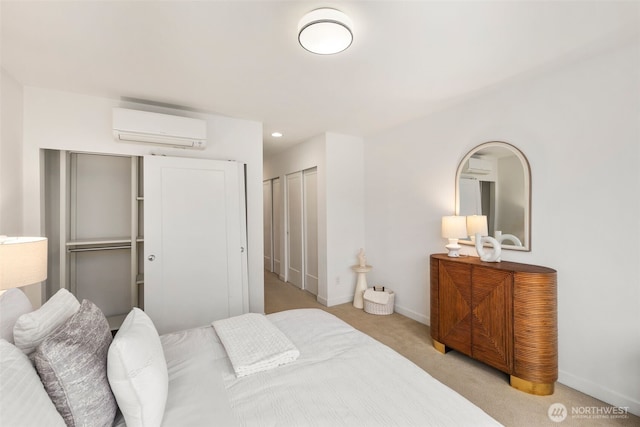 bedroom with light carpet, recessed lighting, baseboards, and a wall unit AC