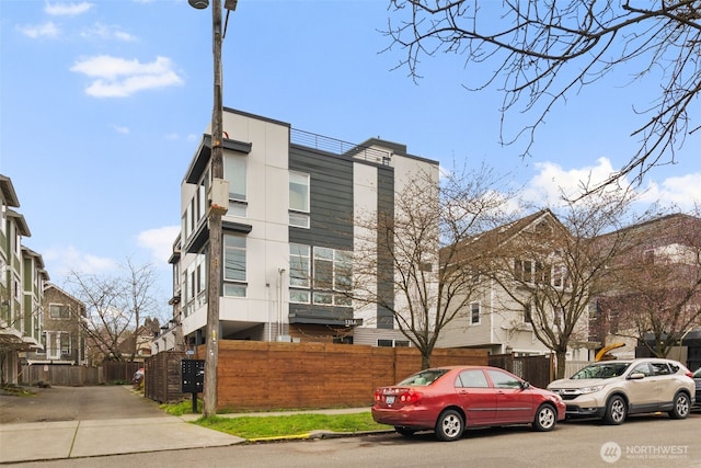 view of building exterior with fence