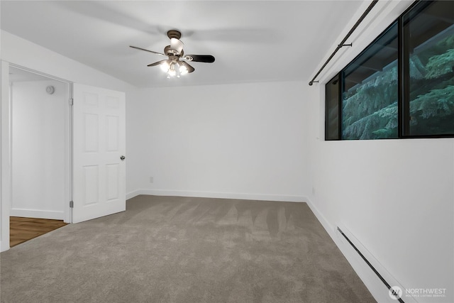 carpeted empty room with baseboards, a baseboard heating unit, and a ceiling fan