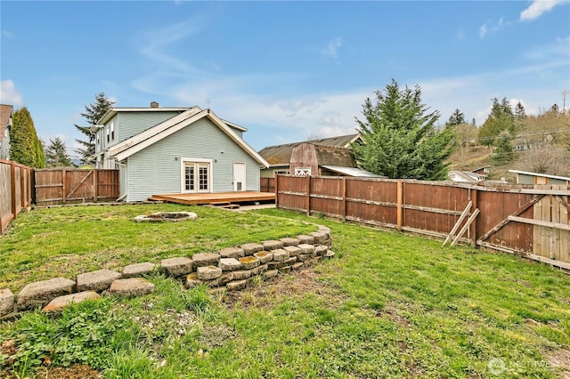 view of yard with a fenced backyard and a wooden deck