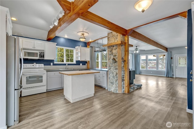 kitchen with white range with electric cooktop, freestanding refrigerator, a sink, butcher block countertops, and white cabinets