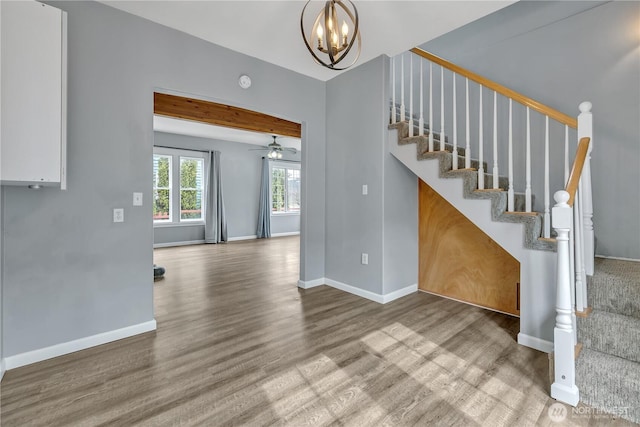 interior space with wood finished floors, baseboards, and a chandelier