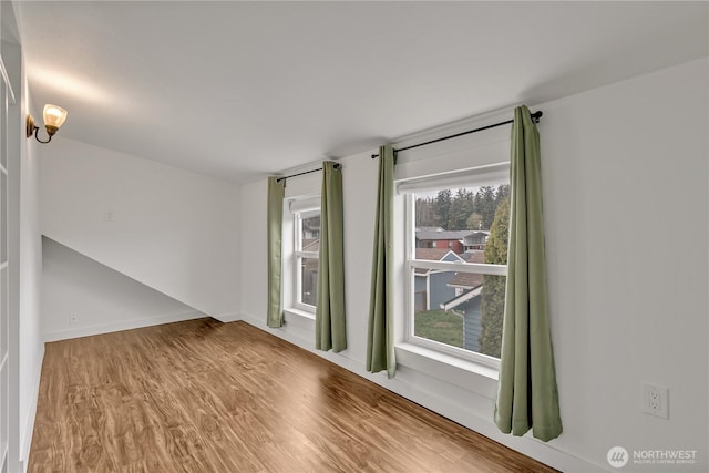 empty room with baseboards and wood finished floors