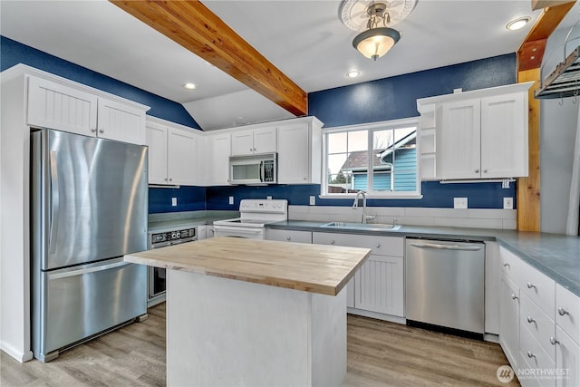 kitchen featuring a sink, butcher block counters, light wood-style floors, and stainless steel appliances