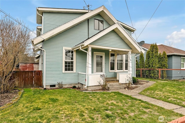 bungalow featuring a front yard, a porch, and fence