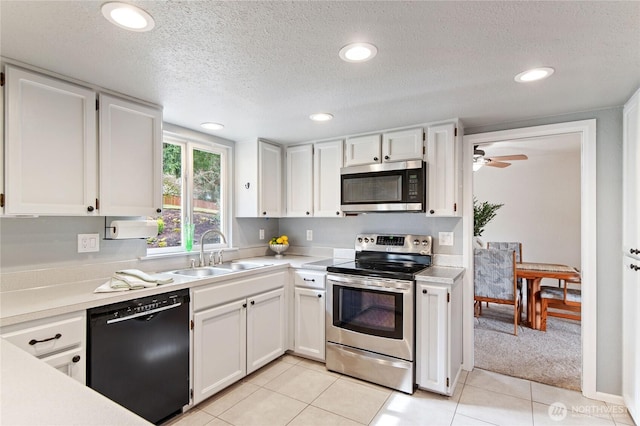 kitchen with white cabinetry, light countertops, appliances with stainless steel finishes, and a sink