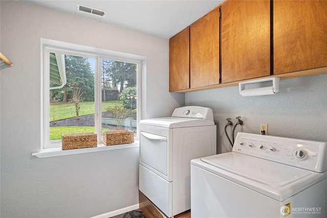 laundry room with washer and dryer, cabinet space, visible vents, and baseboards