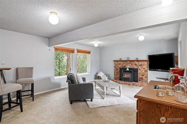 living area featuring light colored carpet, baseboards, and a textured ceiling