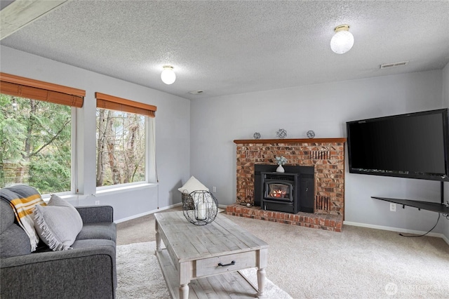 living room with visible vents, a textured ceiling, baseboards, and carpet floors