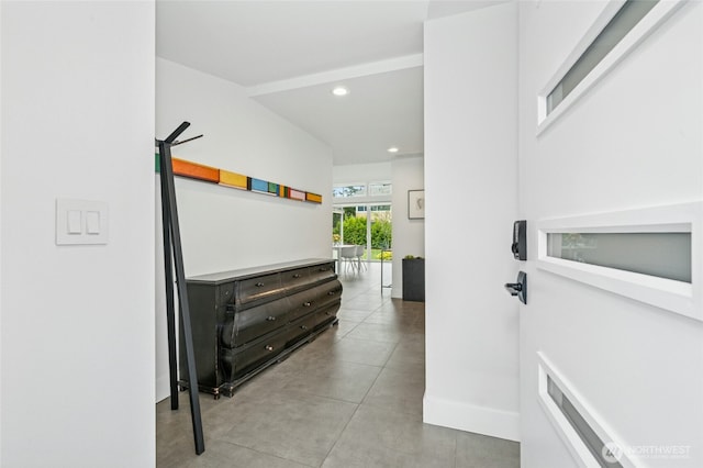 hallway with recessed lighting and baseboards