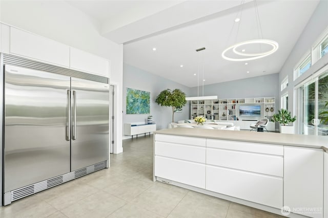 kitchen with white cabinetry, light countertops, light tile patterned floors, and stainless steel built in refrigerator