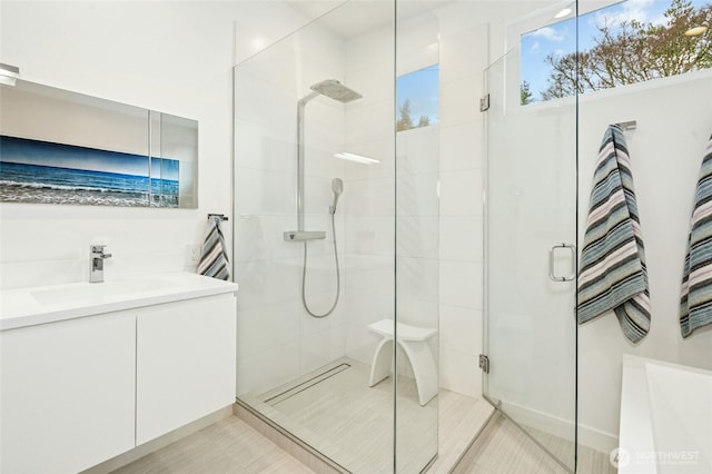 full bath featuring a stall shower and vanity