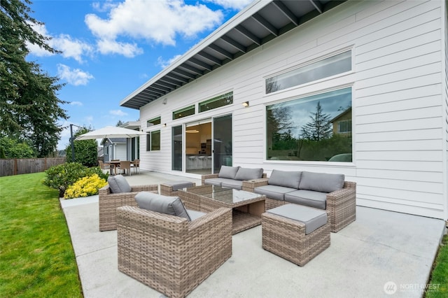 view of patio with outdoor dining space, an outdoor hangout area, and fence