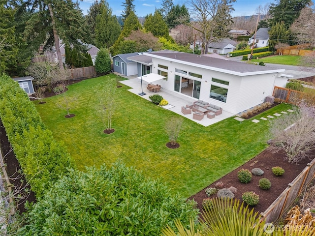 exterior space with a patio, a lawn, and a fenced backyard