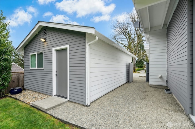 view of outbuilding featuring an outdoor structure and fence